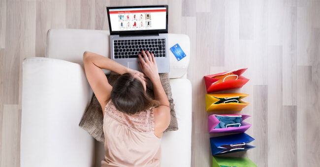 Young,Woman,On,Sofa,Shopping,Online,With,Laptop