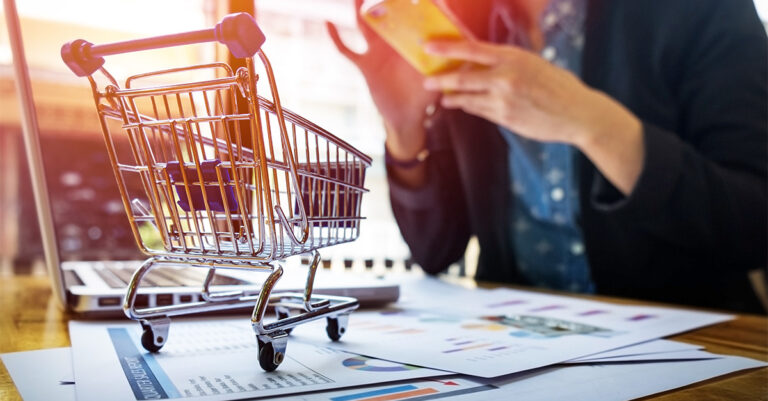 cropped-image-woman-inputting-card-information-key-phone-laptop-while-shopping-online