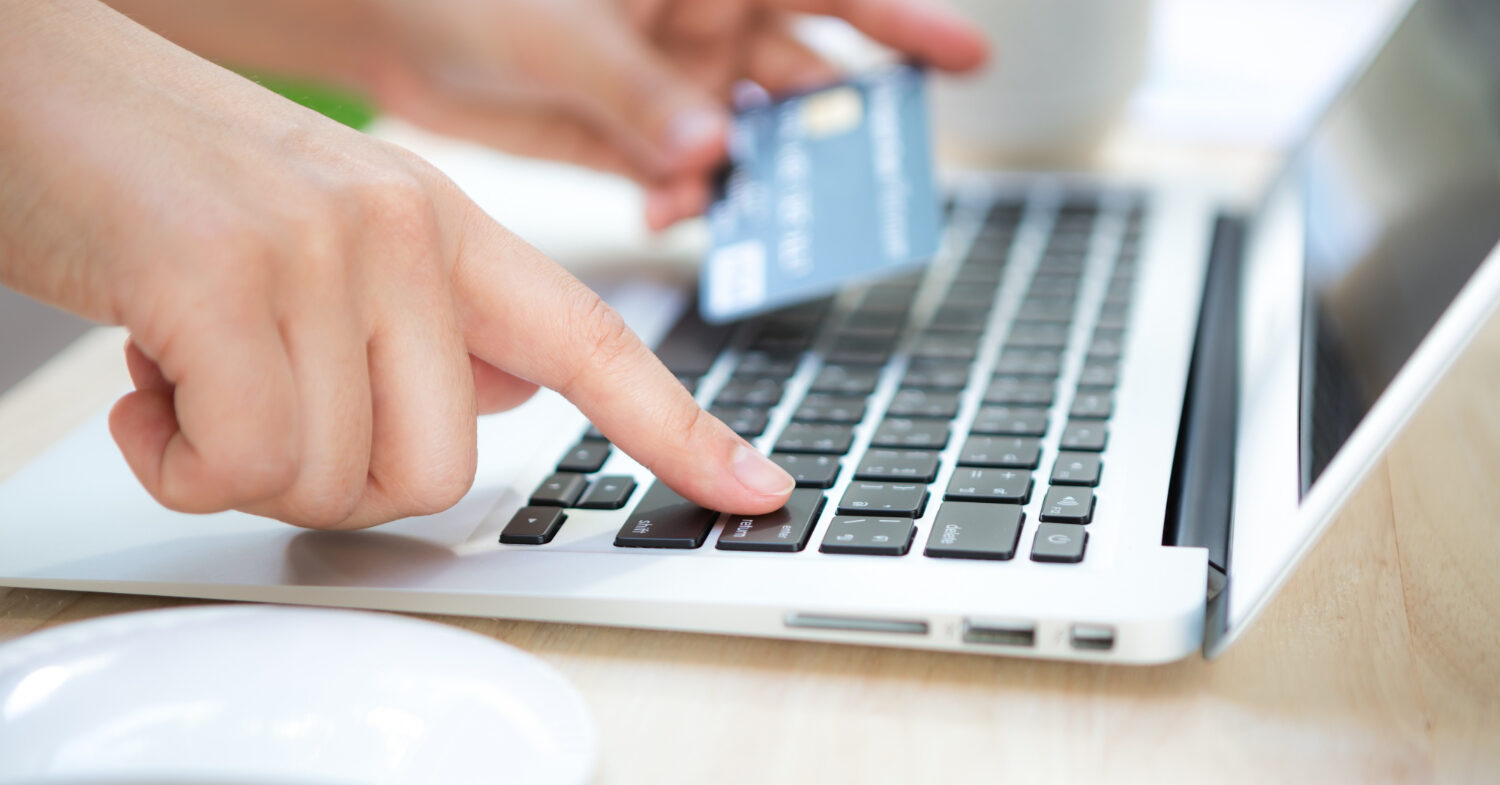 hand-with-credit-card-laptop